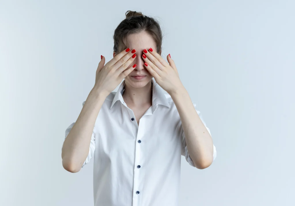 Dos and Don’ts After Cataract Surgery: A Guide to a Smooth Recovery 3 young blonde russian girl closes eyes with hands isolated white space with copy space